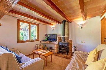 A living room with a fireplace and a flat screen tv