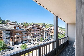 A balcony with a view of a city with a sign that says ' boutique ' on it