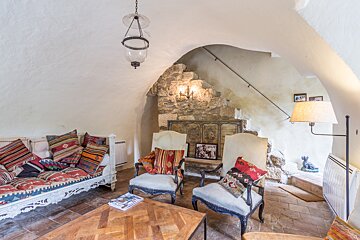 A living room with a couch and two chairs