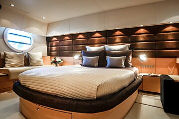 A bedroom with a large bed and a window