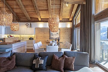 A living room with a couch and a dining table