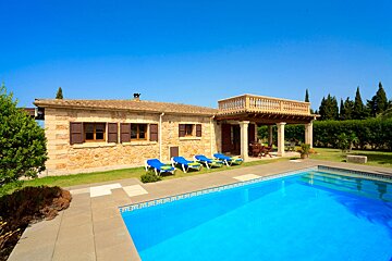 A house with a swimming pool in front of it