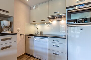 A kitchen with a table and chairs and a couch