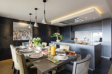 A dining room table with plates of food on it