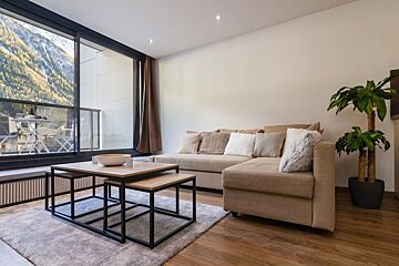 A living room with a couch and two coffee tables