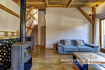 A living room with a couch and a fireplace that says mountain base