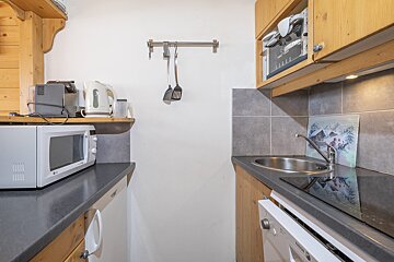 A small kitchen with a microwave and a sink
