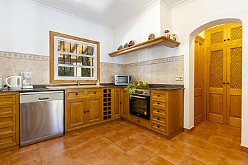 A kitchen with stainless steel appliances and wooden cabinets