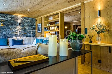 A living room with a stone wall and wooden walls