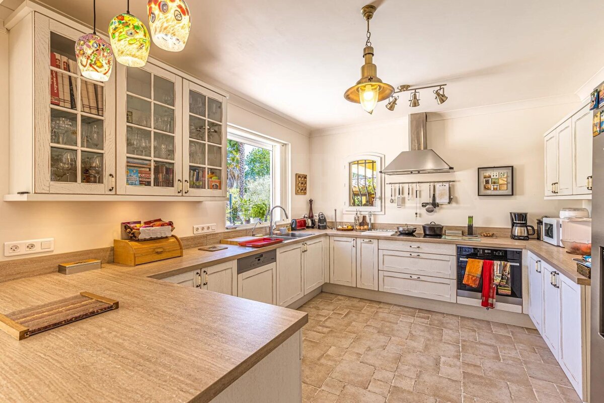 A kitchen with a picture on the wall that says ' french '