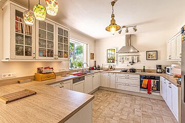 A kitchen with a picture on the wall that says ' french '