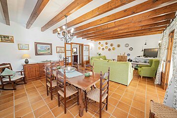 A living room with a dining table and chairs