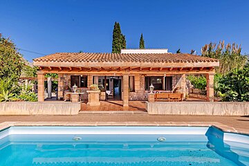 A house with a swimming pool in front of it