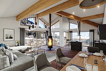 Bright, modern open-plan ski chalet featuring exposed wood beams, a central fireplace, and expansive windows with snowy mountain views.