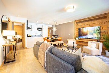 A living room with a couch a chair and a flat screen tv