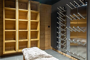 A room with shelves and a stainless steel wall