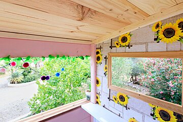 A room with sunflowers on the wall and a mirror