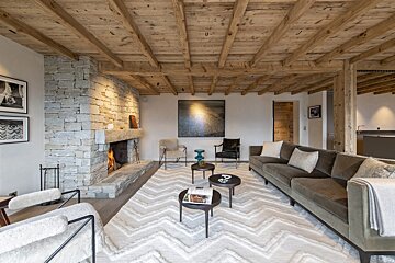 A living room with a couch and chairs and a fireplace