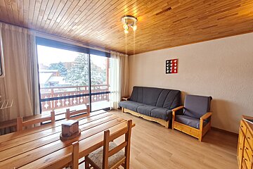 A living room with a table and chairs and a couch