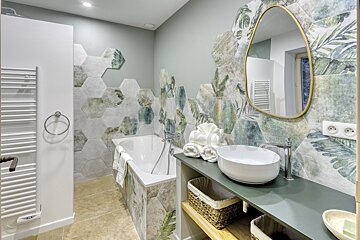A bathroom with hexagonal tiles and a sink