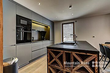 A kitchen with a large island and a sign that says mountain base