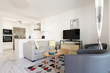 A bottle of wine sits on a table in a living room