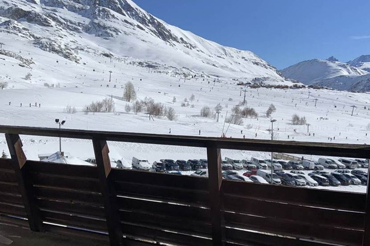 A view of a snowy mountain from a balcony