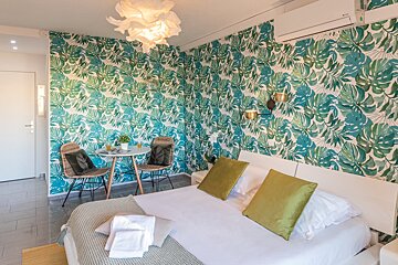 A bedroom with a bed and a small table