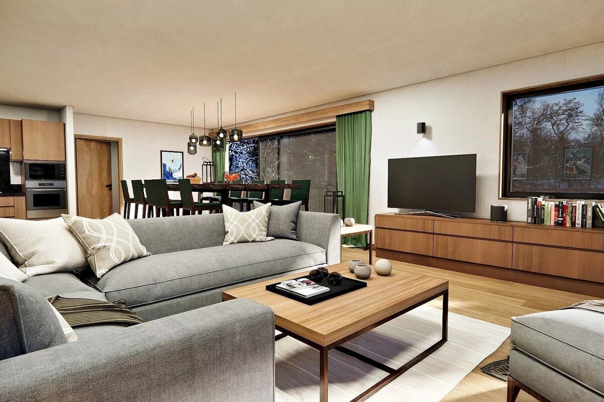 Modern open-plan living room with gray sofa, wooden furniture, TV, dining area with pendant lights, and kitchen. Green curtains frame a large window.