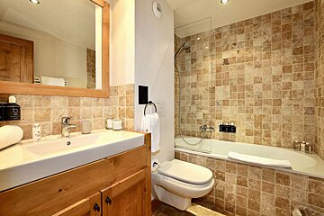 A bathroom with a toilet a sink and a bathtub