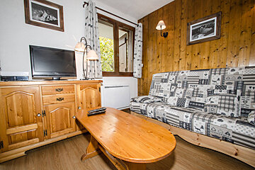 A living room with a couch and a flat screen tv
