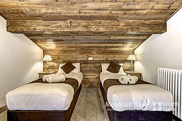 A bedroom with two beds and a sign that says mountain gate knight