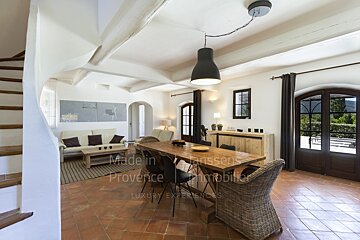 A living room with a table and chairs and the words made in provence