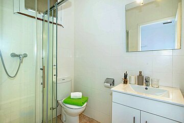 A bathroom with a toilet a sink and a mirror