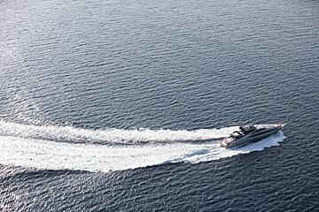 A boat is floating on top of a body of water