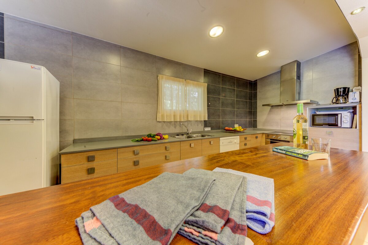 A bottle of wine sits on a counter in a kitchen