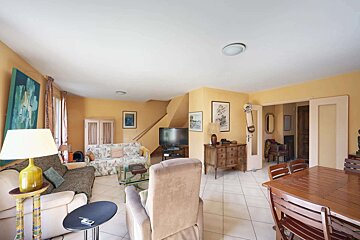 A living room with a couch and chairs and a table