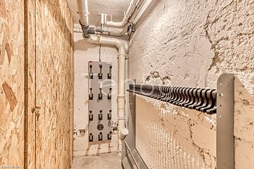 A picture of a room with pipes and a sign that says ' a ' on it