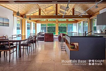 A kitchen and dining area with the words mountain base knight frank on the bottom