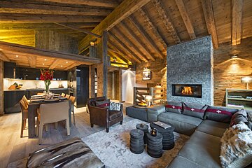 A living room with a sectional couch and a fireplace