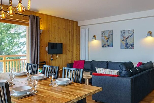 A living room with a dining table and chairs