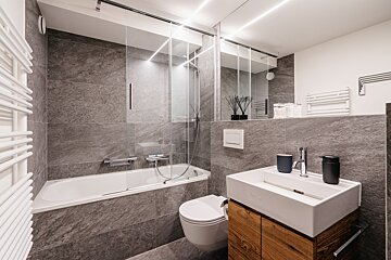 A bathroom with a bathtub toilet and sink