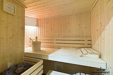 A wooden sauna with the words white management on the bottom