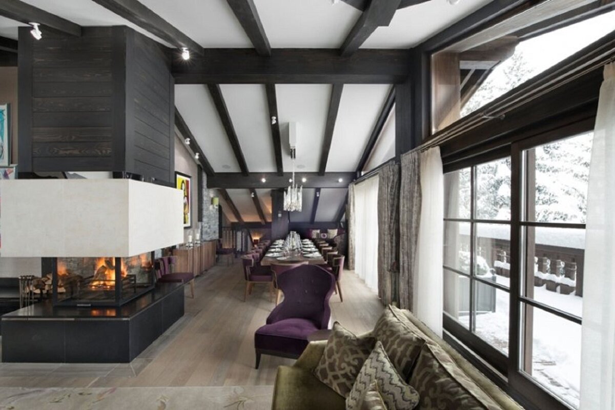 A living room with a fireplace and a purple chair