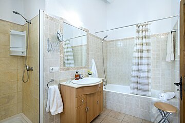 A bathroom with a sink a shower and a bathtub