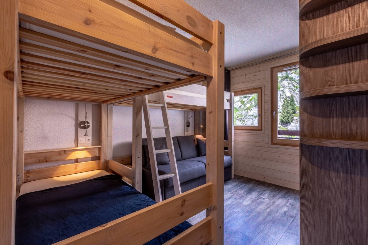 A bedroom with bunk beds and a couch