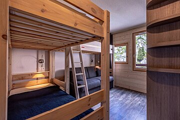 A bedroom with bunk beds and a couch
