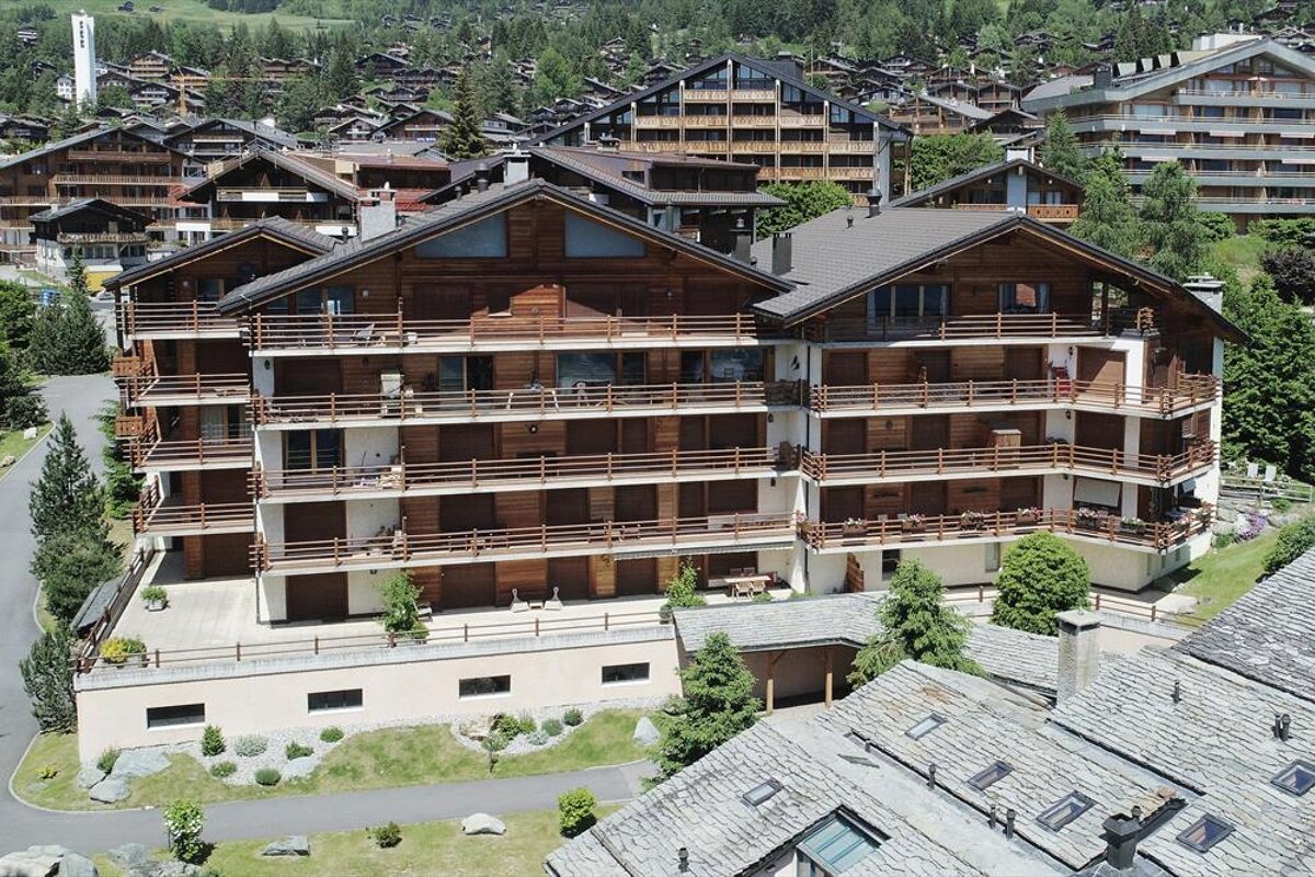 An aerial view of a large apartment building with balconies