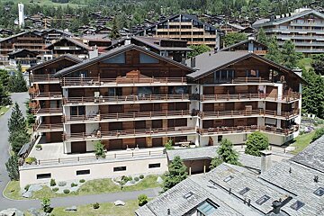 An aerial view of a large apartment building with balconies