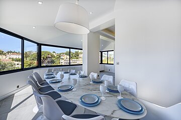 A dining room table with plates and glasses on it
